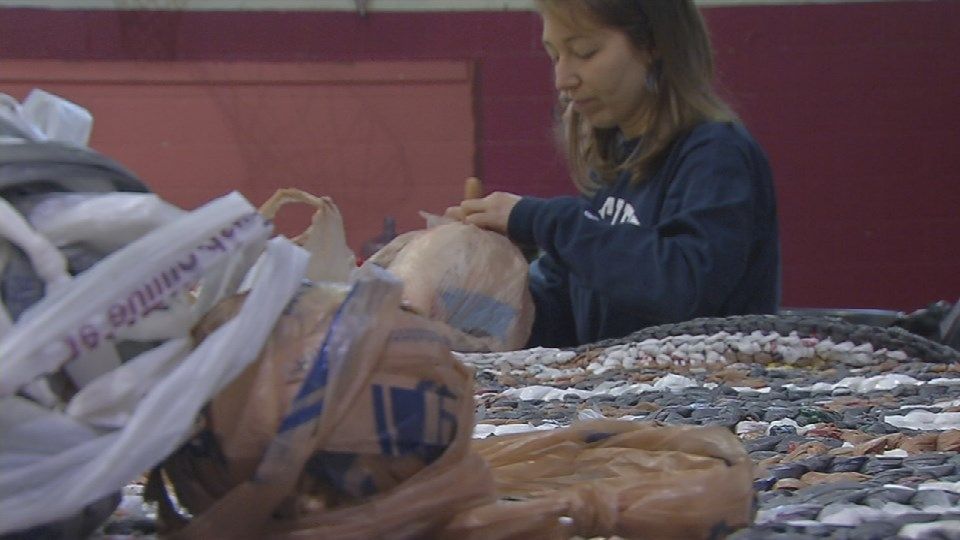 Volunteers with Compassionate Creations use plastic grocery bags to