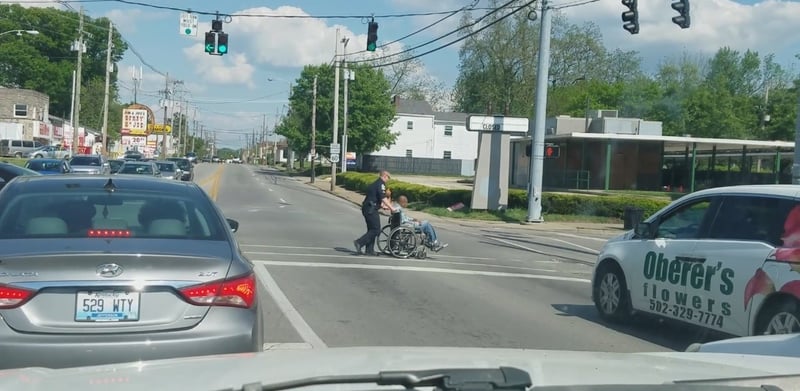 Video of LMPD Sgt. Chris Keith helping a man in a wheelchair is being widely praised. (courtesy Amanda Lynn Blias)
